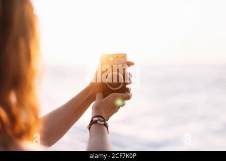 Female photographer taking picture with camera Stock Photo