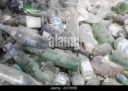 Bucharest, Romania - September 1, 2020: Empty bottles are piled up in a glass recycling facility. Stock Photo