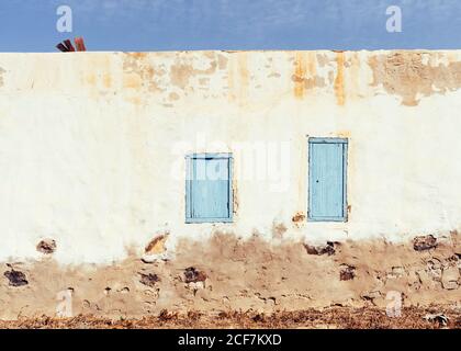 Closed window in rustic wall of old house Stock Photo