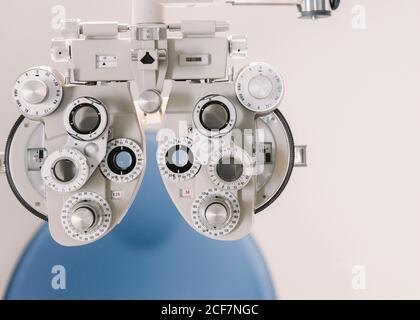 Modern Vision Test Equipment And Chair Against White Wall In Optician Office In Clinic Stock Photo Alamy