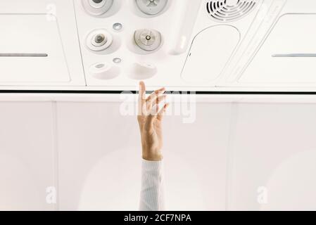 person pressing button on panel up airplane Stock Photo