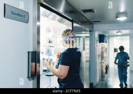 side view of woman in cap and swimming suit surfing in ocean Stock Photo -  Alamy