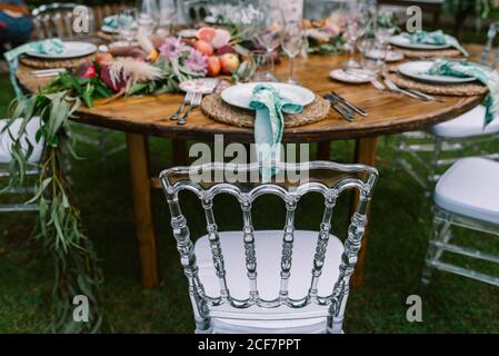 Wedding table decoration in rustic style placed outdoors Stock Photo