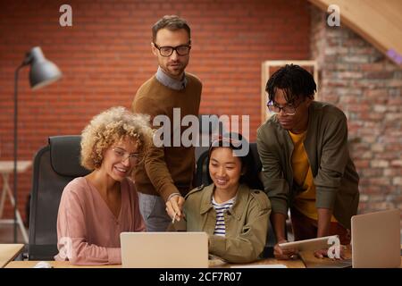 Creative business team using laptop in their online work they working working over presentation in team at office Stock Photo