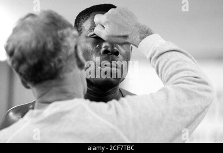 Frank Bruno gets ready to spar at Trimon Construction in east London. 19 March 1992. Photo: Neil Turner Stock Photo