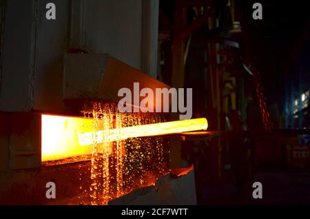 Steel quenching at high temperature in industrial furnace at the workshop of a forge plant. Process of cooling, heat treatmen. Blacksmith and metallur Stock Photo