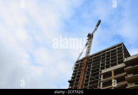Tower cranes constructing a new building at construction site. Stock Photo