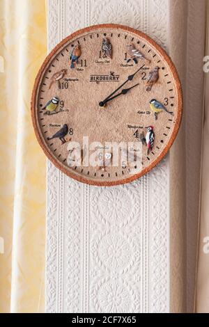 Decorative clock hanging in a home in the living room. Stock Photo