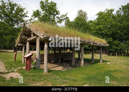 Replica of traditional building with grass roof in a farmhouse at Vitlycke Museum of the Bronze Age, Tanumshede (Unesco World Heritage Site), Sweden Stock Photo