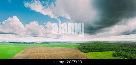 Scenic Sky With Rain Clouds Over Countryside Rural Field Meadow Landscape In Sunny Spring Day. Scenic Sky With Rain Clouds On Horizon. Agricultural Stock Photo