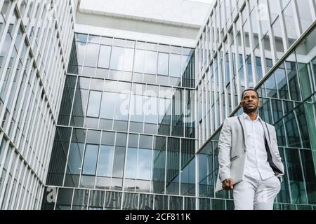 Black man holding laptop on street Stock Photo