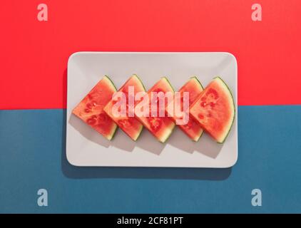 Summer juicy fruit watermelon on colorful background from above Stock Photo