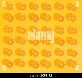 Set of beautiful wallpaper with sliced oranges on bright yellow background. Stock Photo