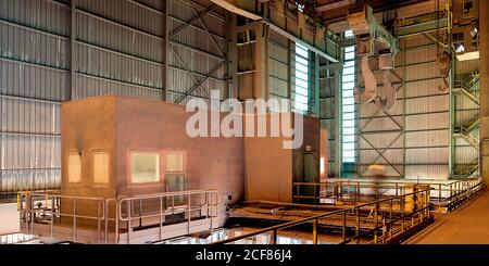 Interior of spacious workshop with large metal walls and construction inside of industrial factory in Asturias Stock Photo