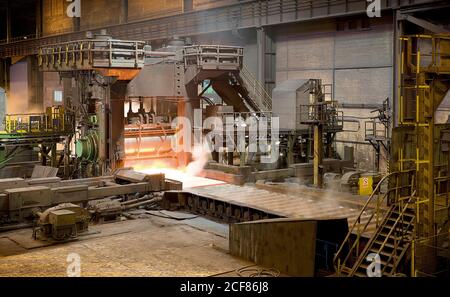 Burning forge inside of spacious metal workshop ready to produce metal structure in industrial building of modern factory in Asturias Stock Photo