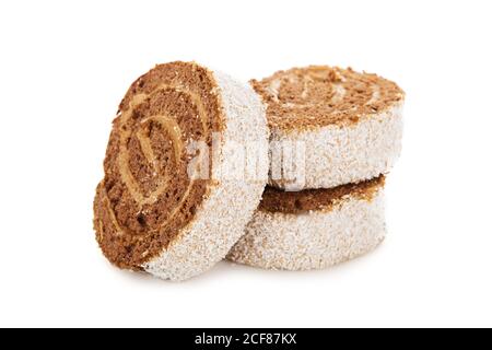 Slices of sweet roll cake decorated with Coconut chips isolated on white background Stock Photo