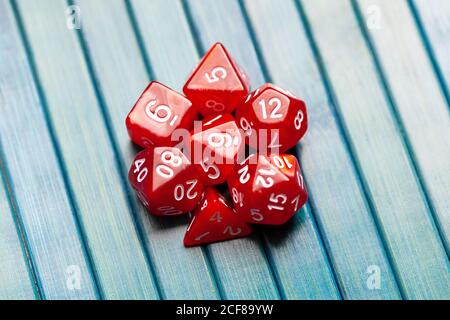 Lots of simple red RPG game dice, polyhedral dice set for role playing games and scenarios, top view. Dices group closeup. Tabletop board games Stock Photo