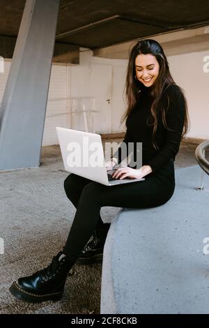 Female freelancer using laptop in courtyard Stock Photo