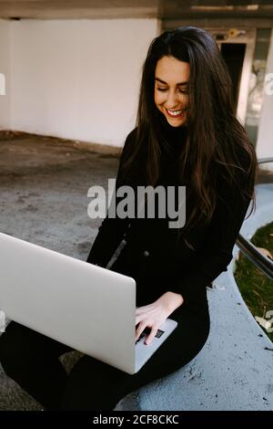 Female freelancer using laptop in courtyard Stock Photo