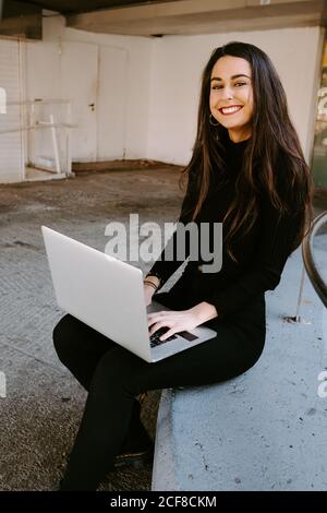 Female freelancer using laptop in courtyard Stock Photo