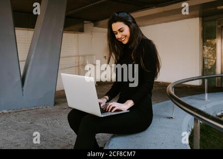 Female freelancer using laptop in courtyard Stock Photo