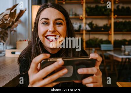 Young lady using smartphone in cafe Stock Photo