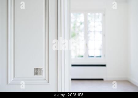 Metal switch on white wall in room with trendy minimalist interior Stock Photo