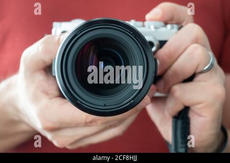 Camera held by a man horizontally Stock Photo