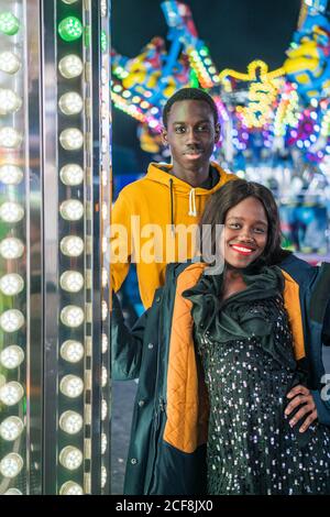 Black man playing claw crane for girlfriend Stock Photo