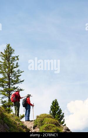 Eldery mountain hikers pointing at the view Stock Photo