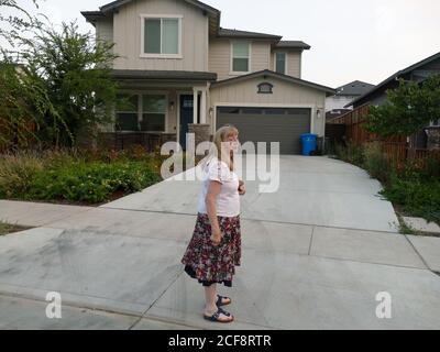 Santa Rosa, USA. 31st Aug, 2020. Astrid Granger stands on the plot of her old house, which is now newly built on, in Coffey Park. In 2017, she and her husband lost their house in the Coffey Park district in the so-called Tubbs fire in Santa Rosa. (to dpa 'California turns into fire hell - no end in sight') Credit: Barbara Munker/dpa/Alamy Live News Stock Photo