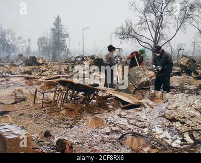 Santa Rosa, USA. 31st Aug, 2020. Photographed from a tablet, the photo shows the Granger family searching for remains in the ashes of their burnt down house in 2017. In 2017, they lost their house in the Coffey Park neighborhood in the so-called Tubbs fire in Santa Rosa. (to dpa 'California becomes a fire hell - no end in sight') Credit: Astrid Granger/Barbara Munker/dpa/Alamy Live News Stock Photo