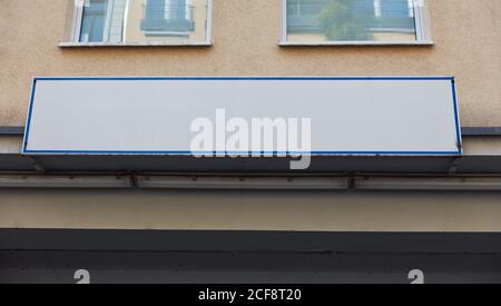 White company sign mock-up template on the house wall of a building Stock Photo