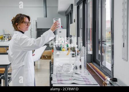 Mature chemist conducting experiment in lab Stock Photo