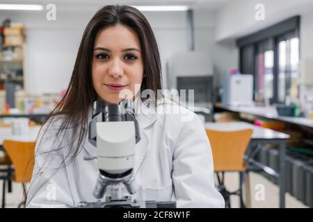 Young female scientist with microscope Stock Photo