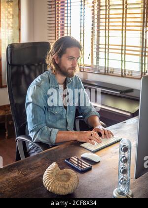 man using computer in apartment Stock Photo