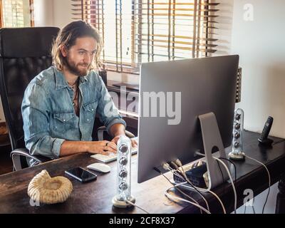 man using computer in apartment Stock Photo