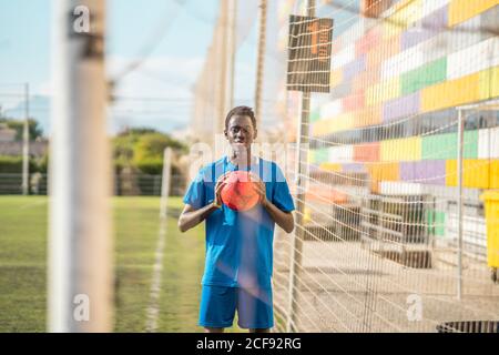 Black teenager on football field Stock Photo