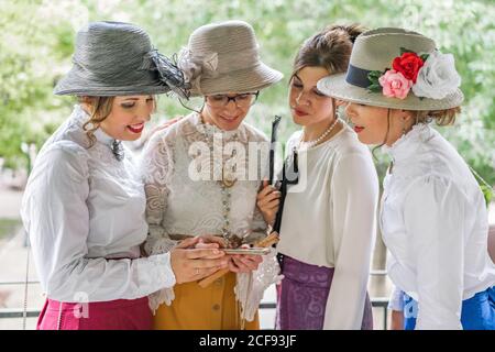 Vintage ladies using smartphone in garden Stock Photo