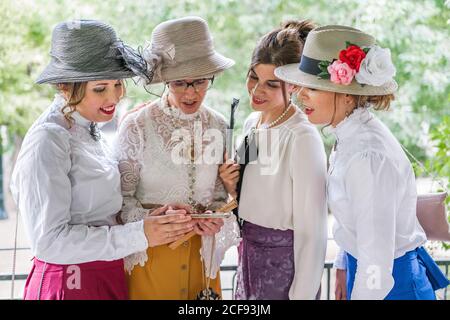 Vintage ladies using smartphone in garden Stock Photo