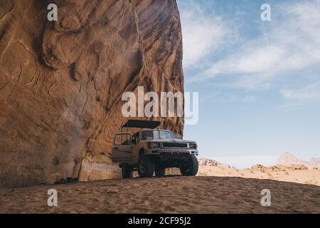 A typical 4-wheeler jeep in Wadi Rum desert during lunch time Stock Photo