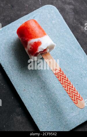 Close-up view of watermelon and cream popsicle laying on fancy plate Stock Photo