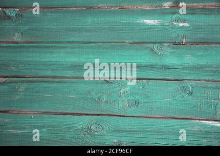 old, grunge wood panels painted into teal green used as background Stock Photo