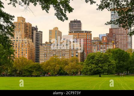 New York City, USA - October 7, 2019: View across the Sheep Meadow in Central Park to the skyline of adjacent buildings near Lincoln Square. Stock Photo