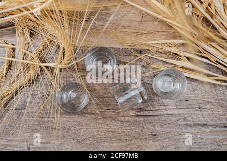 Clear whiskey shots on wooden table Stock Photo