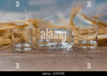 Clear whiskey shots on wooden table Stock Photo