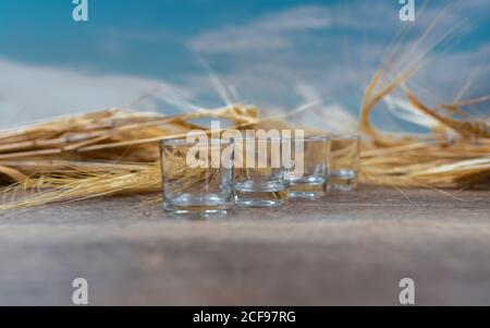 Clear whiskey shots on wooden table Stock Photo