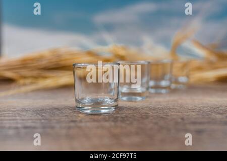 Clear whiskey shots on wooden table Stock Photo