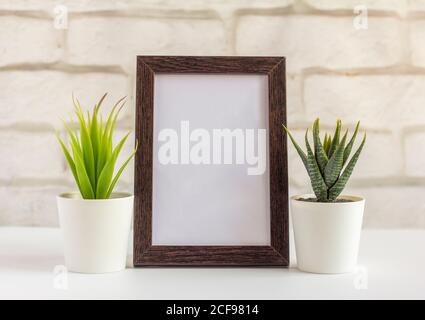 An empty photo frame in a dark frame on a table or shelf with a copy of the place Stock Photo
