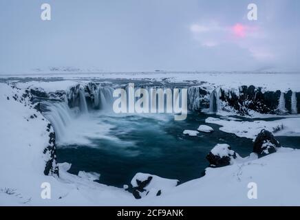 Magnificent view of powerful stream of water reaching end of cliff and falling down in Iceland Godafoss waterfall Stock Photo